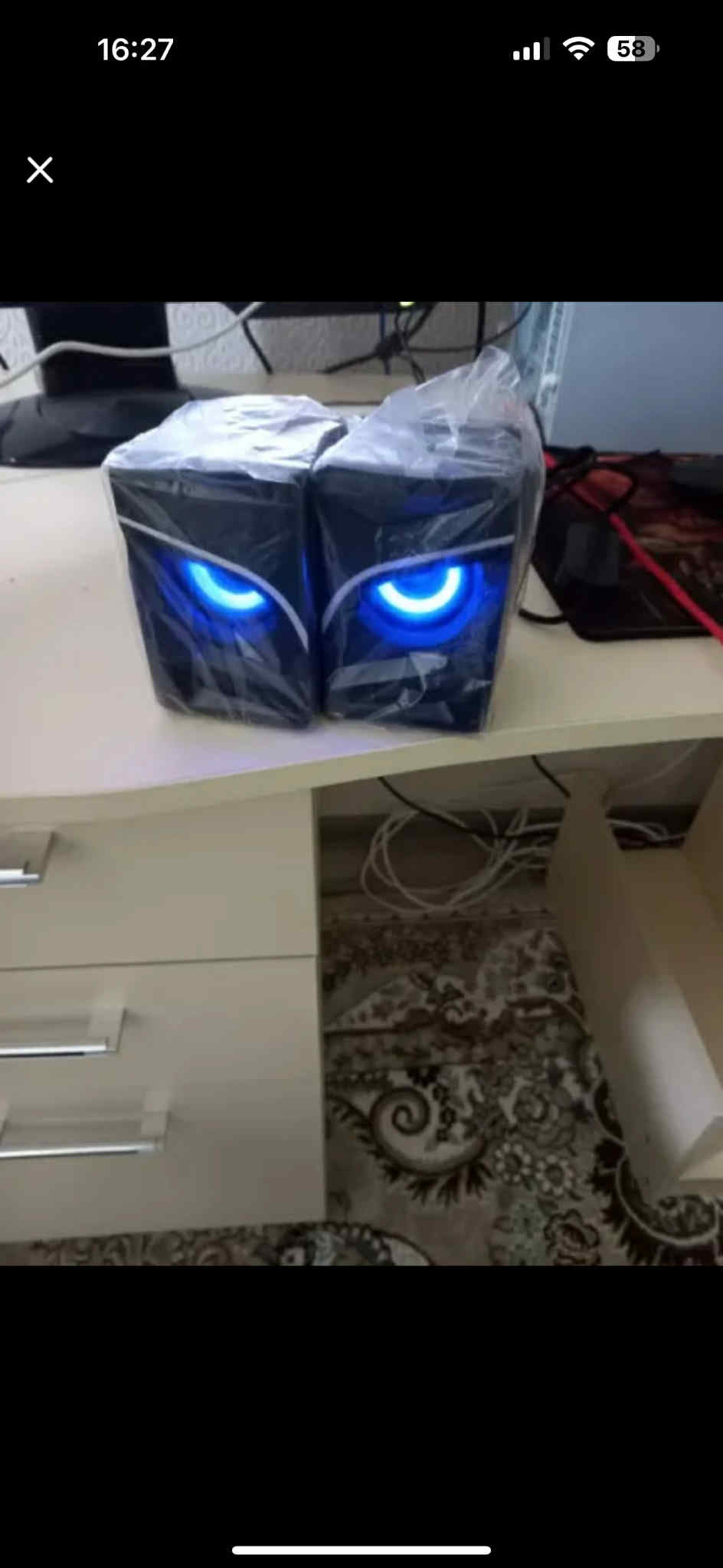 Computer case with glowing blue lights on a desk